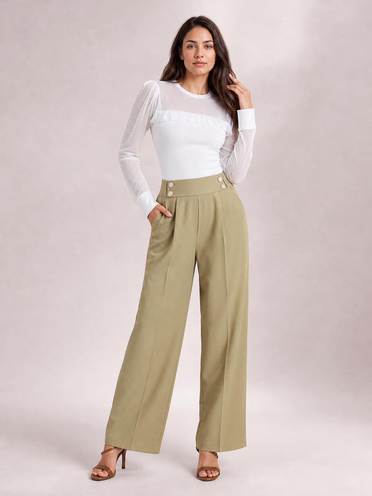 Model poses in olive high-waisted wide-leg pants with a smooth waistband, button accents, side pockets, and a relaxed full-length silhouette.