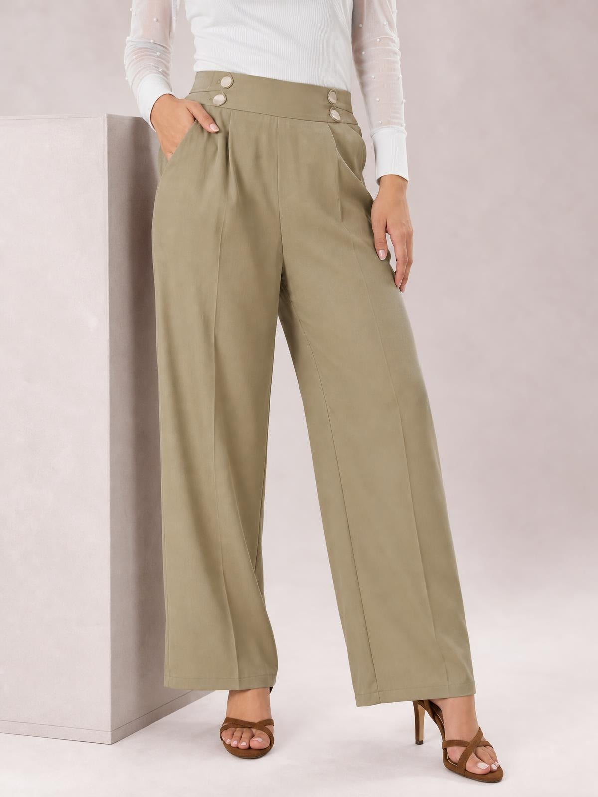 Model poses in olive high-waisted wide-leg pants with front pleats, buttoned waistband, side pockets, and a relaxed full-length silhouette.