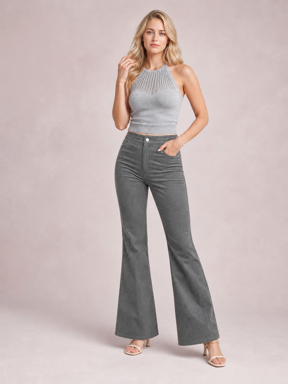 A model poses in high-waist gray bootcut pants with a fitted hip, front button closure, slant pockets, and gently flared full-length legs.