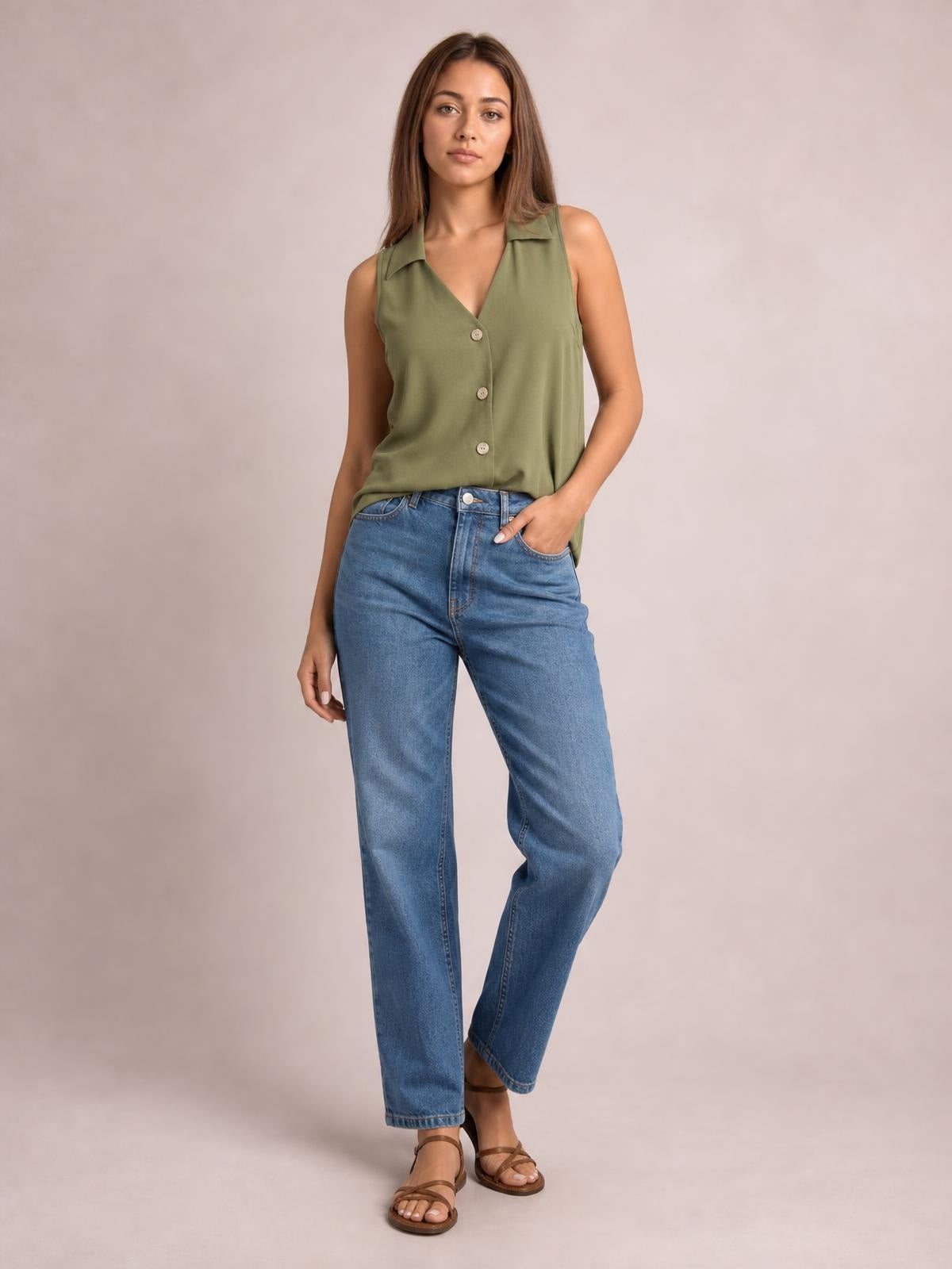 Model wears an olive green Johnny collar button-up tank with a sleeveless, relaxed silhouette and three visible front buttons, standing with one hand in her pocket.