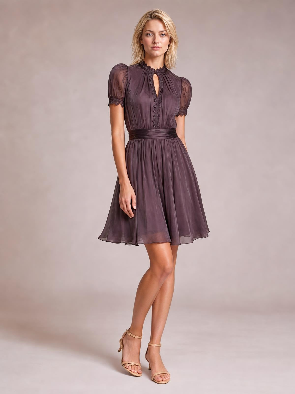 A model poses in a plum A-line dress with puff sleeves, lace-trimmed collar and front, a defined waist, and a flowing knee-length skirt.