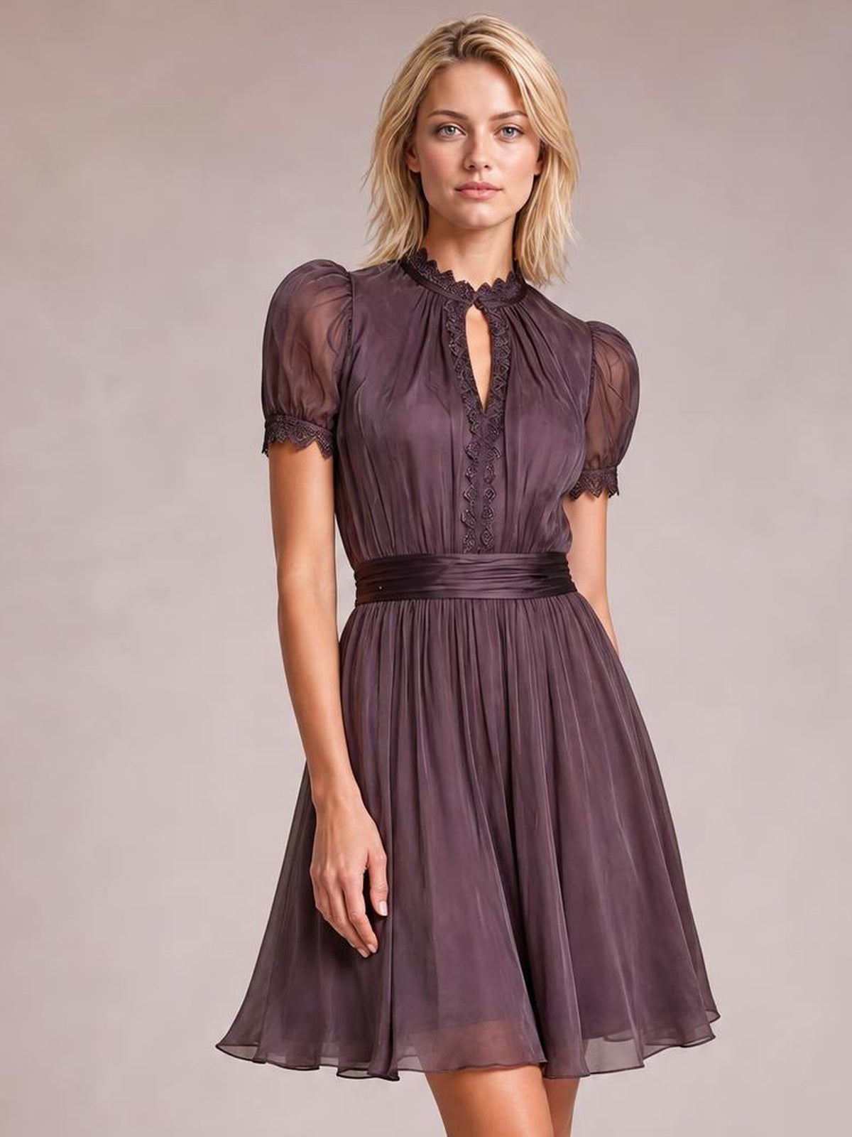 A model stands facing forward in a deep plum A-line dress with puff sleeves, lace-trimmed neckline and cuffs, a defined waist, and a softly flared skirt.