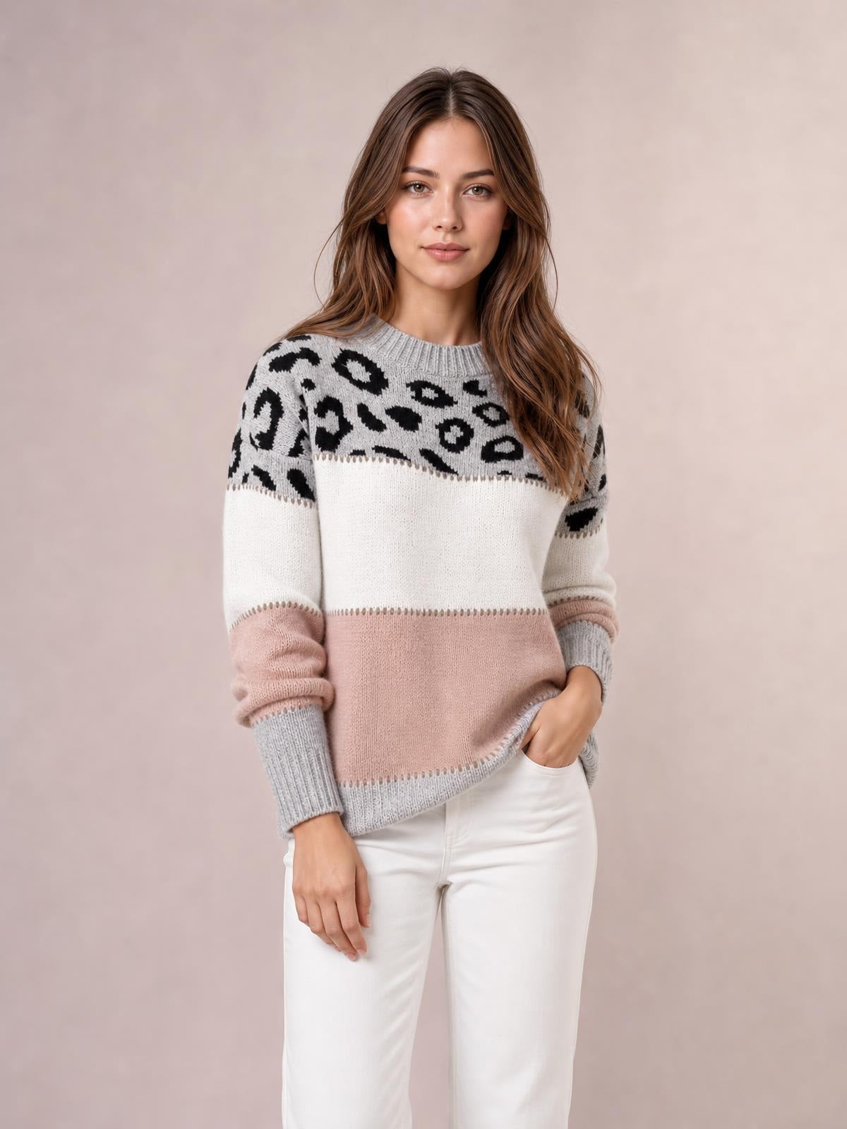 Model wearing a long-sleeve leopard color block sweater with a gray ribbed crew neck and cuffs, white and blush pink panels, and a relaxed silhouette.