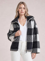 Model wears a black-and-white plaid zip-up jacket with long sleeves, a relaxed silhouette, textured panels, and the front left open.