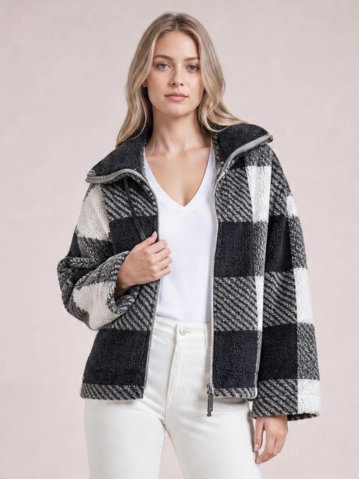 Model wears a black-and-white plaid zip-up jacket with long sleeves, a relaxed silhouette, textured panels, and the front left open.