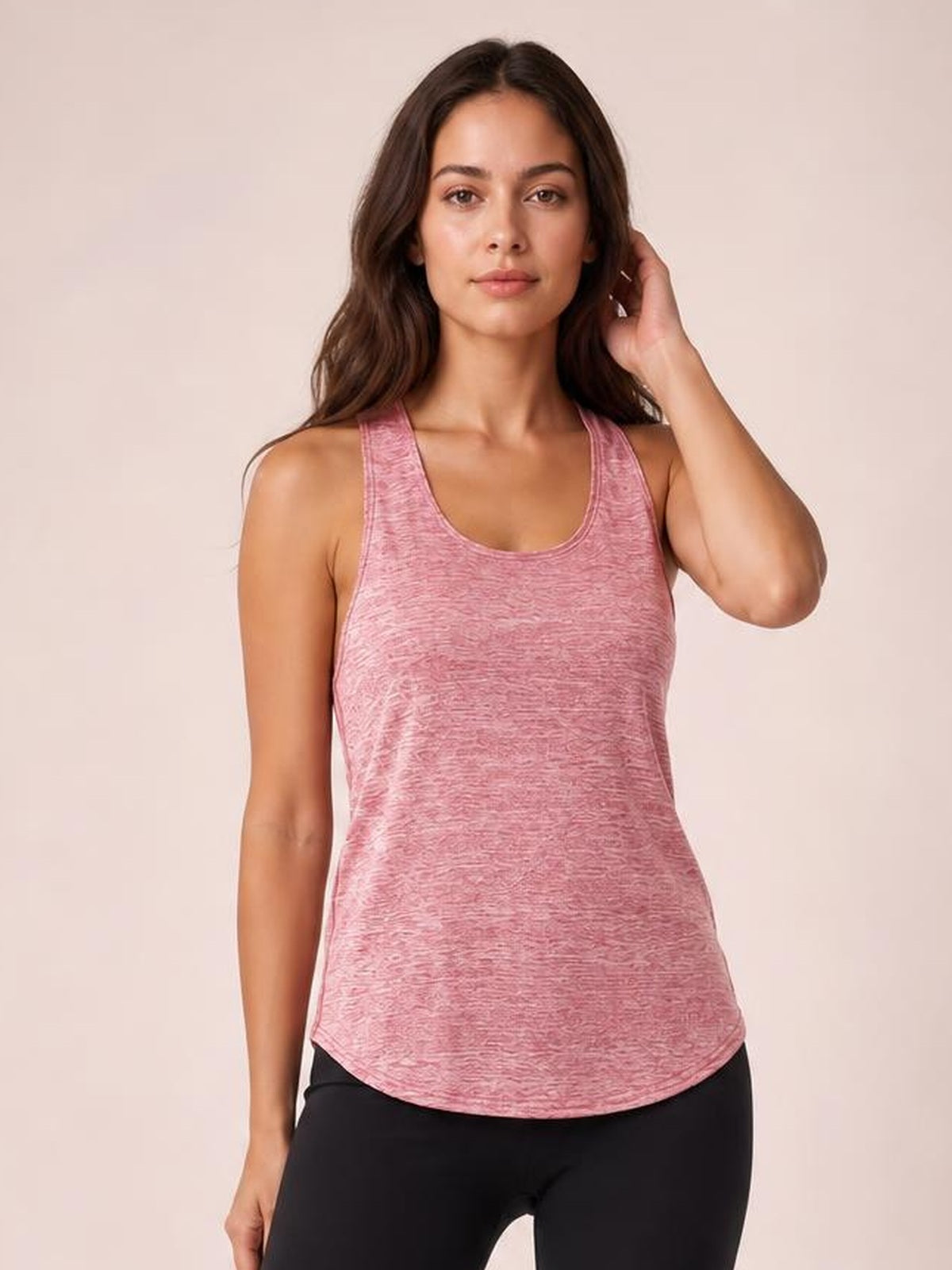 Model wears a pink scoop neck wide strap active tank with a relaxed straight silhouette, rounded hem, and textured construction.