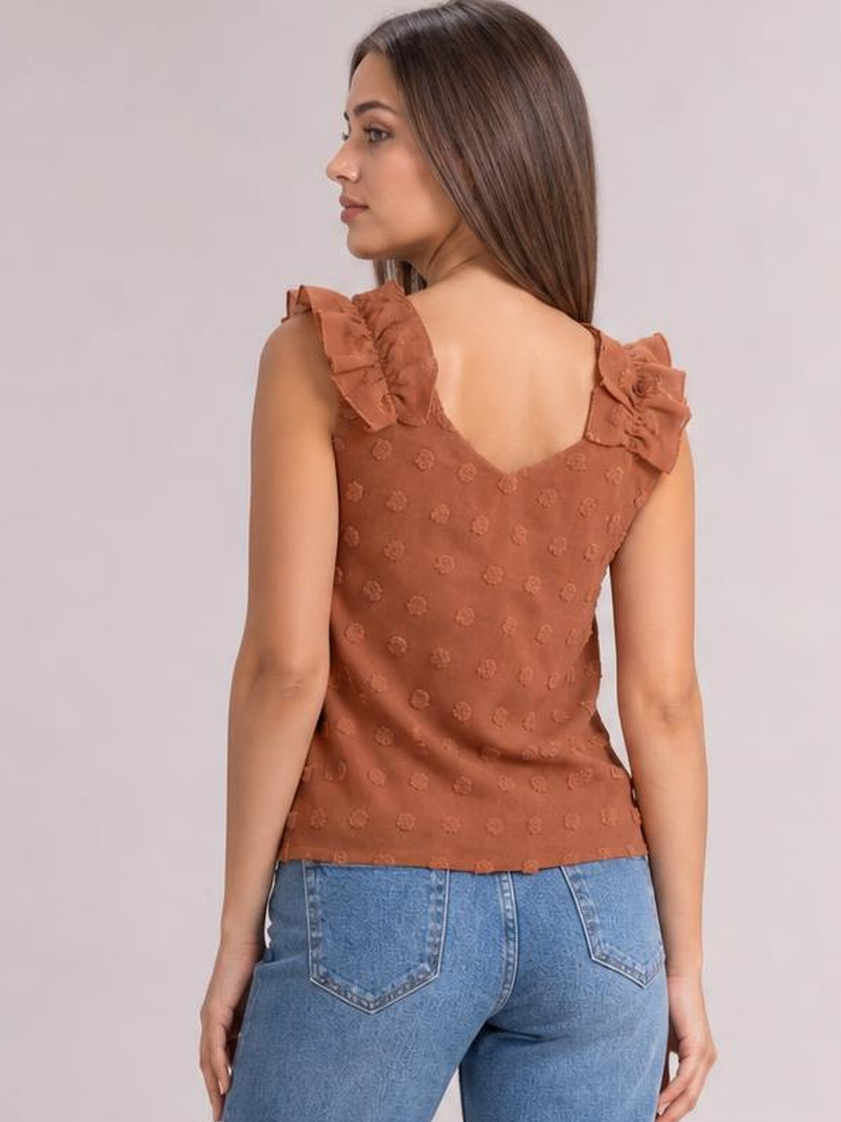 Model shown from behind wearing a rust-brown Swiss dot tank with ruffled shoulder straps, a low back neckline, and a fitted silhouette.