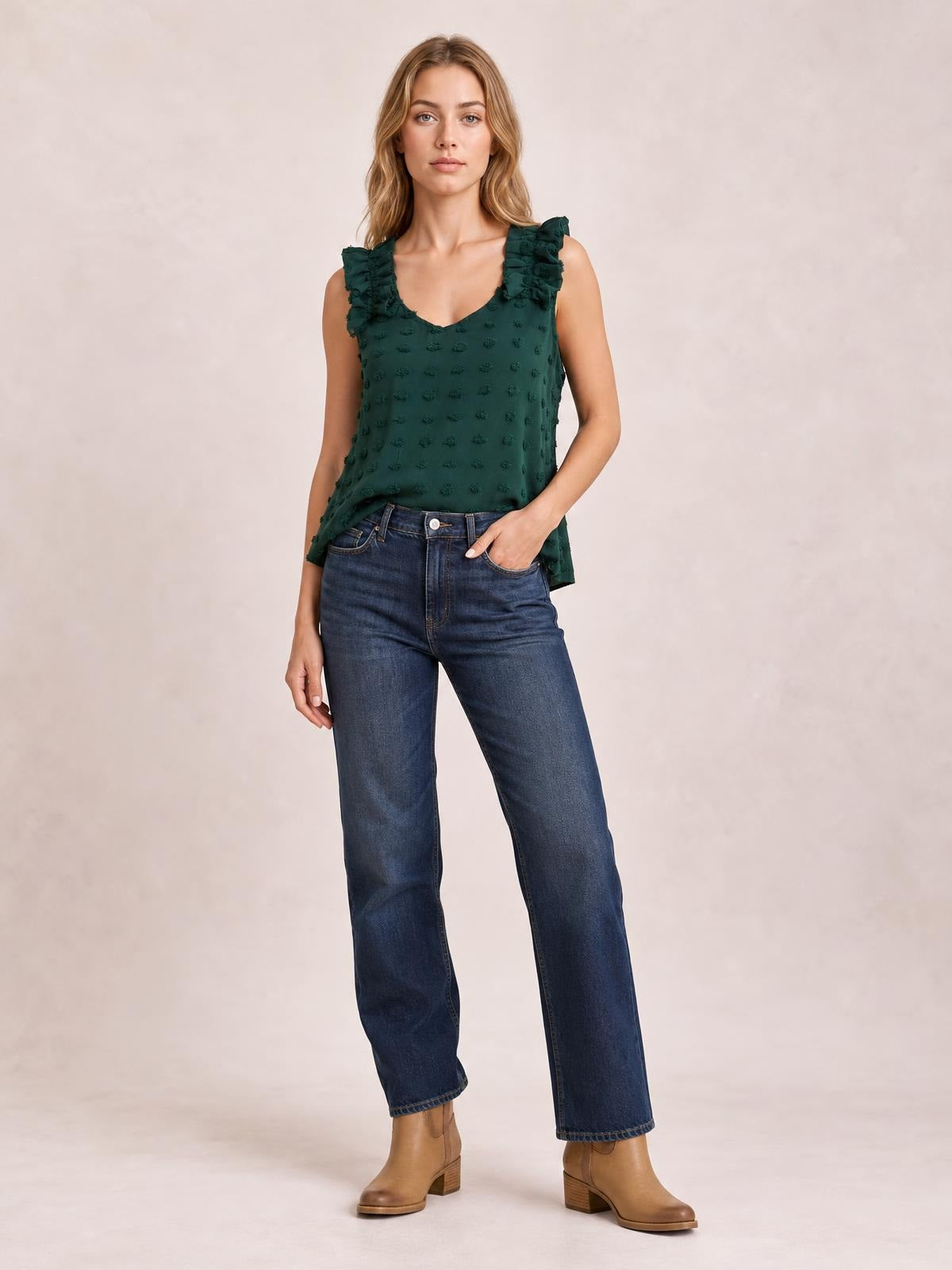 Model poses in a dark green Swiss dot V-neck tank with ruffled shoulder straps and a relaxed, slightly flared silhouette.