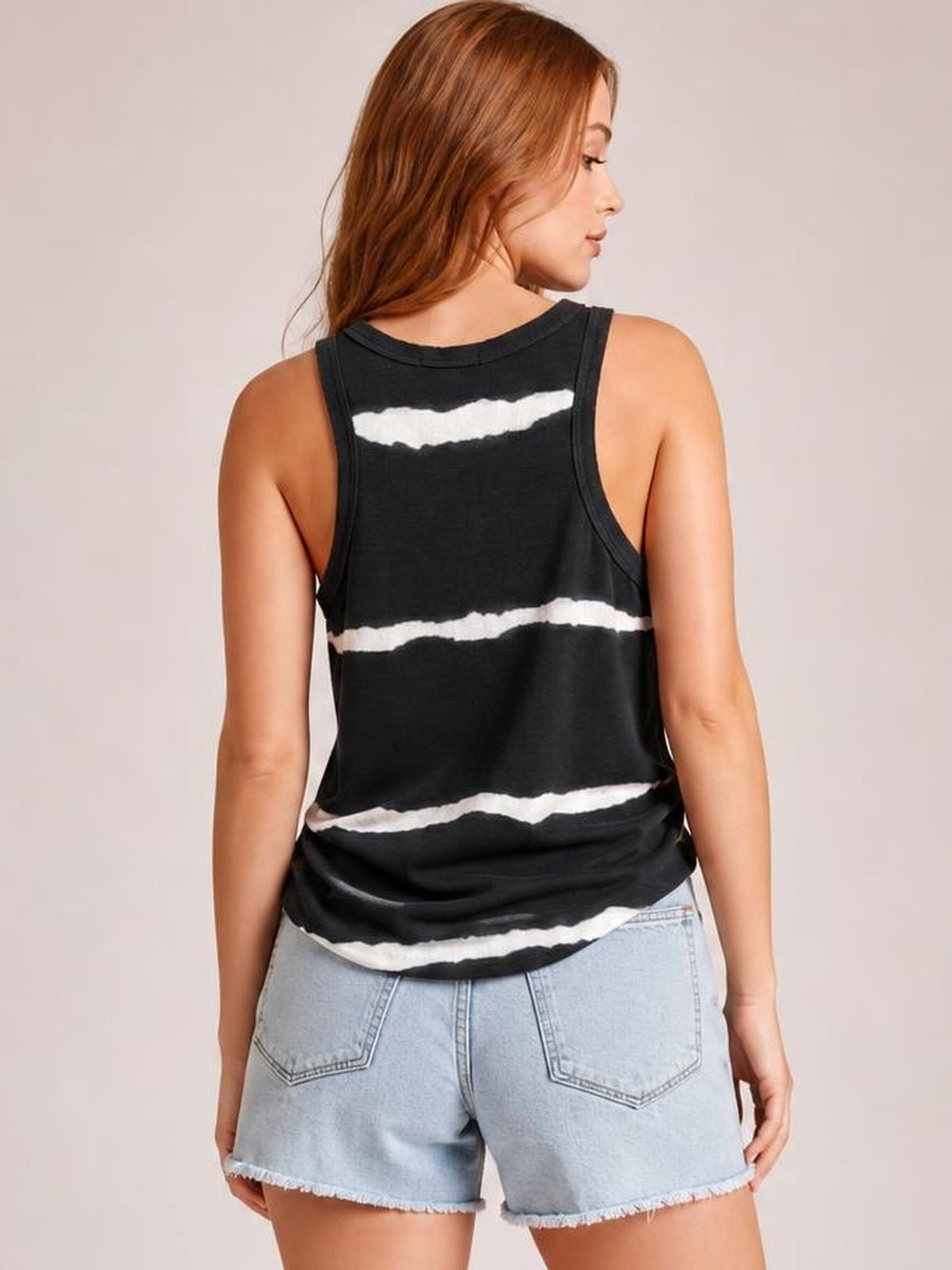 Model shown from the back wearing a black tie-dye round neck tank with white horizontal stripes, wide armholes, and a relaxed, slightly curved silhouette.