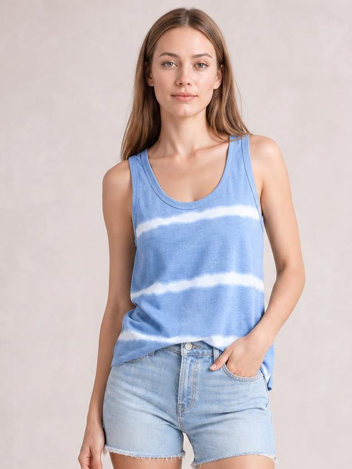 Model wearing a blue tie-dye round neck tank with wide shoulder straps, a relaxed straight silhouette, and a slightly stretchy opaque construction.