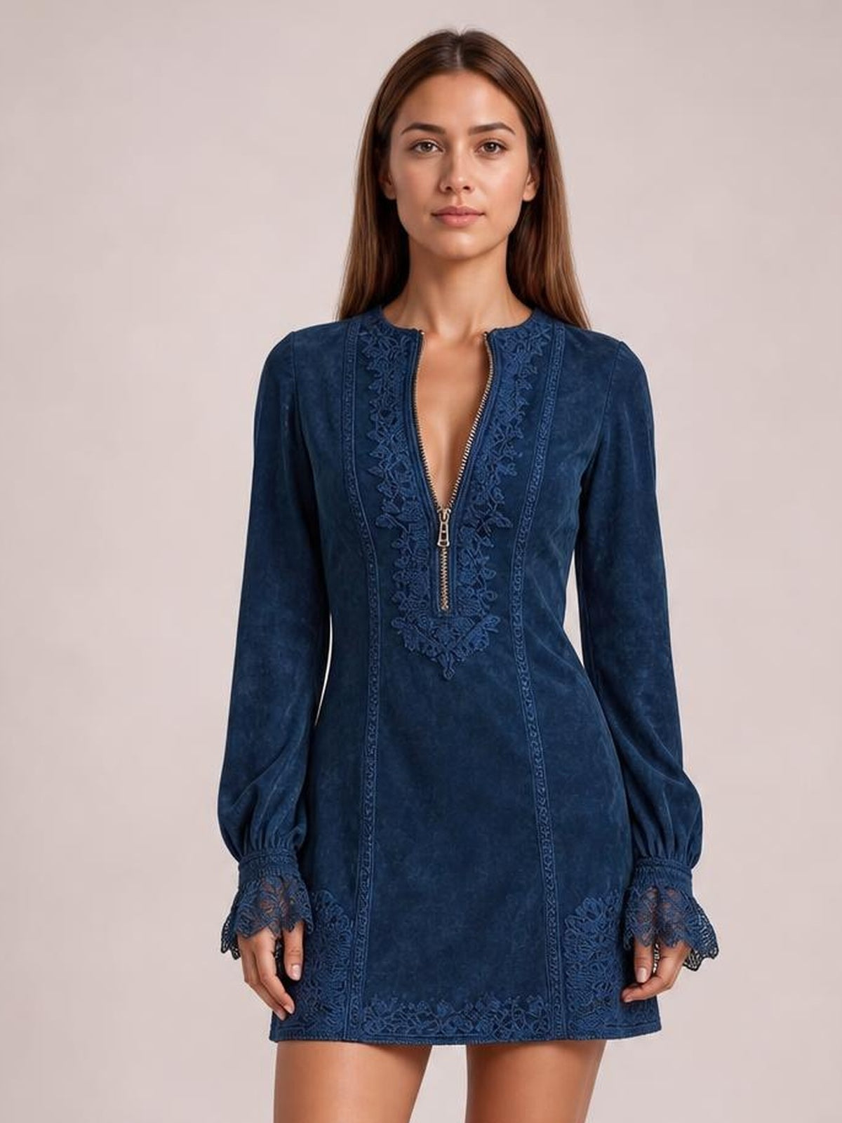 Model stands facing forward in a navy blue long-sleeve mini dress with a relaxed A-line silhouette, zip-front neckline, and lace-trimmed cuffs and hem.
