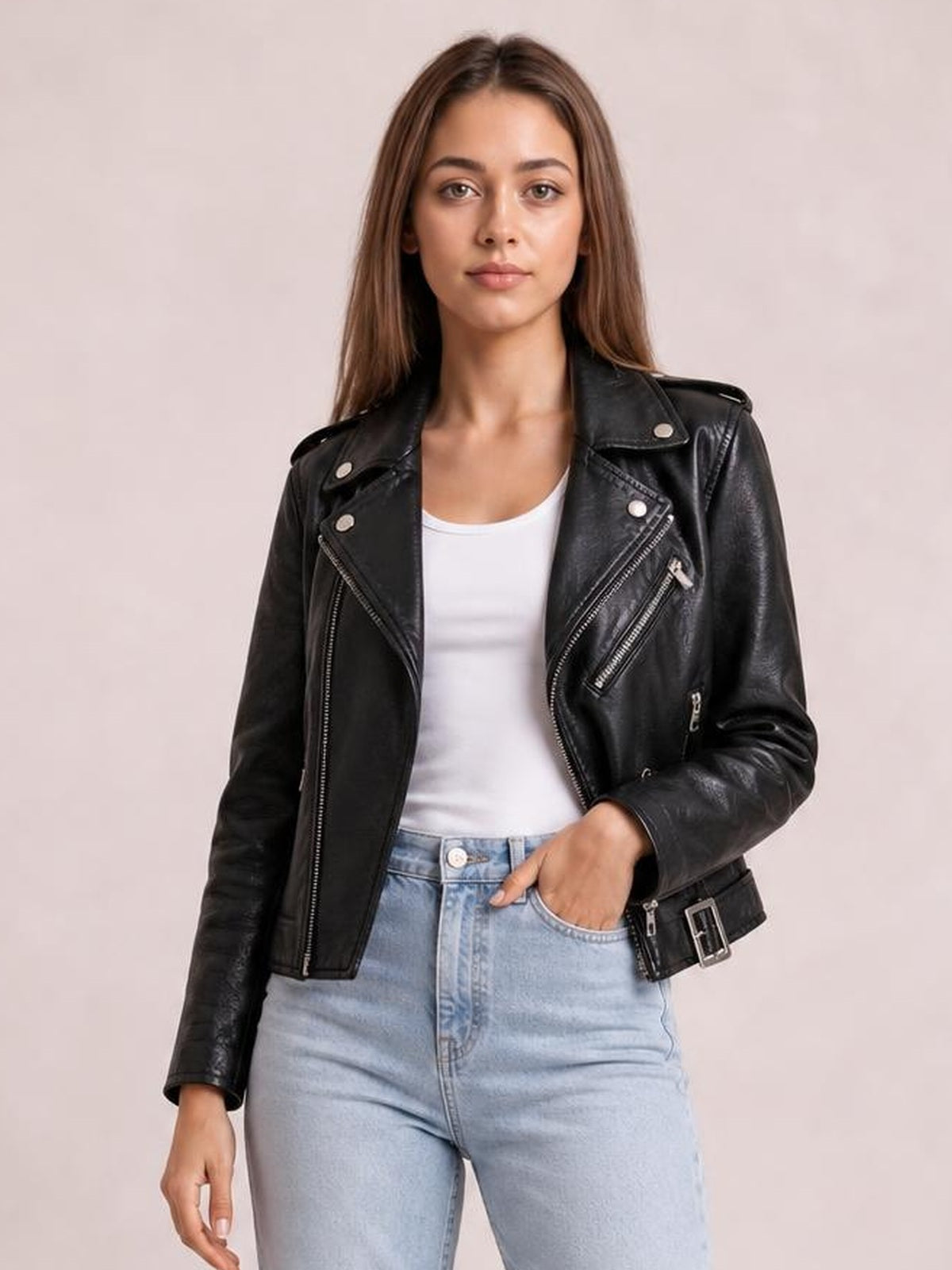 Model poses in a black leather-look motorcycle biker jacket with an asymmetrical zip front, wide lapels, zip pockets, shoulder tabs, and a belted hem.