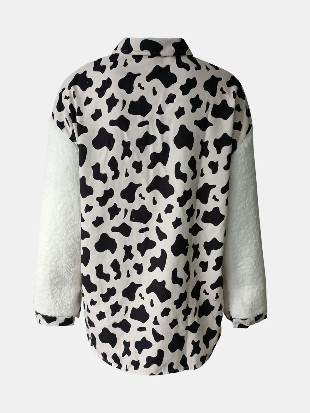 A fuzzy long sleeve jacket with a black-and-white cow-print body, plush white sleeves, a structured collar, and a relaxed straight silhouette.