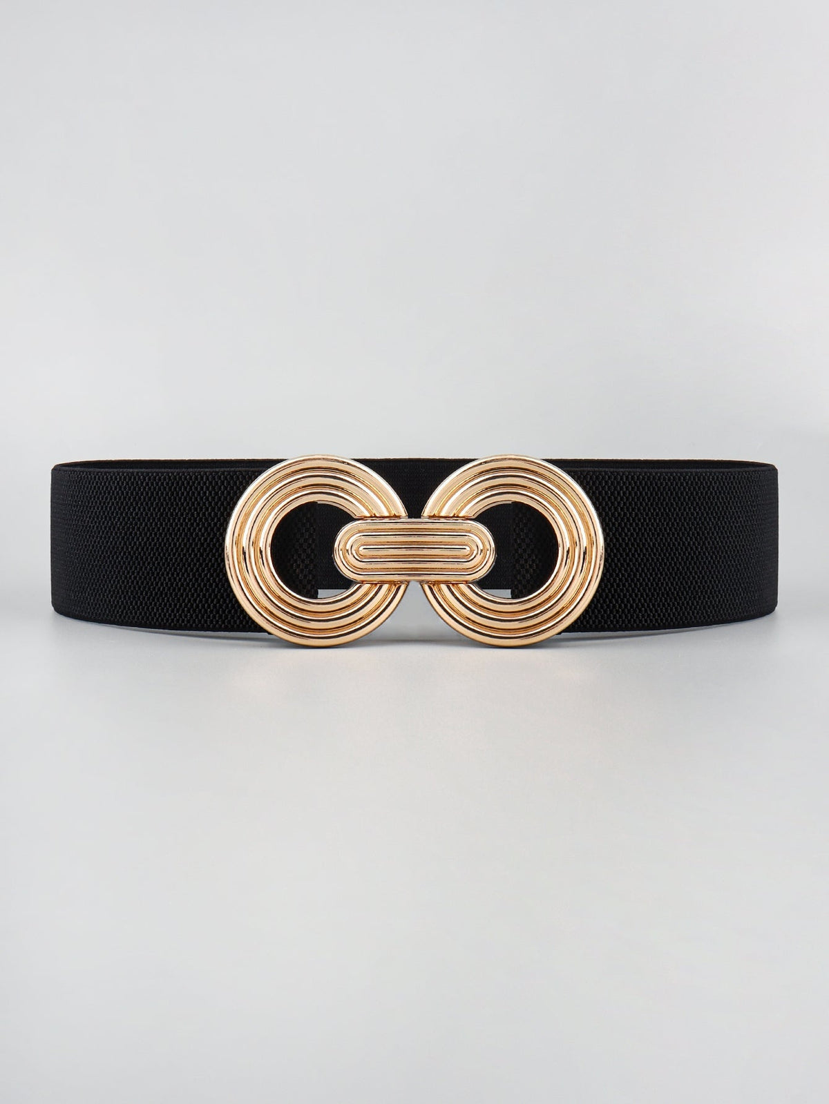 Black elastic wide belt with a sleek 2-inch profile and a dimensional gold-tone geometric alloy buckle featuring interlocking rounded forms.