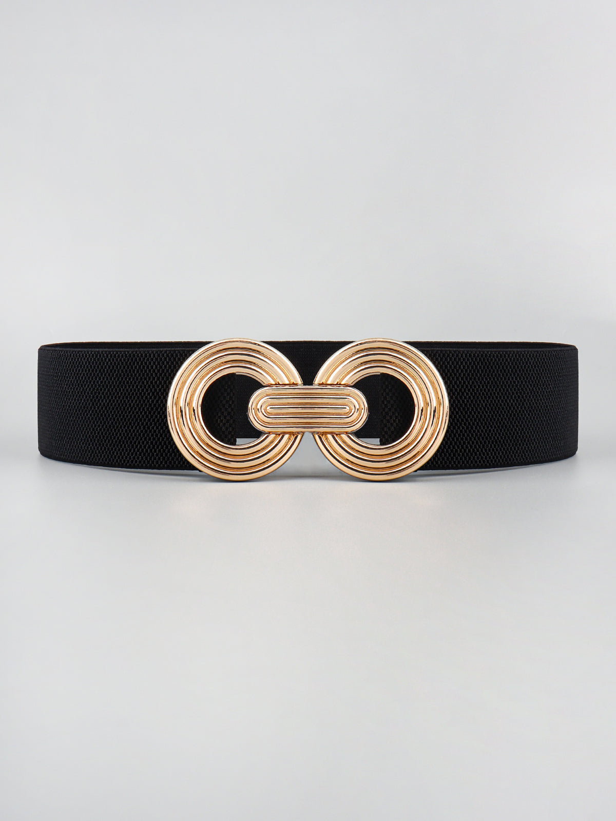 Black elastic wide belt with a sleek 2-inch profile and a dimensional gold-tone geometric alloy buckle featuring interlocking rounded forms.