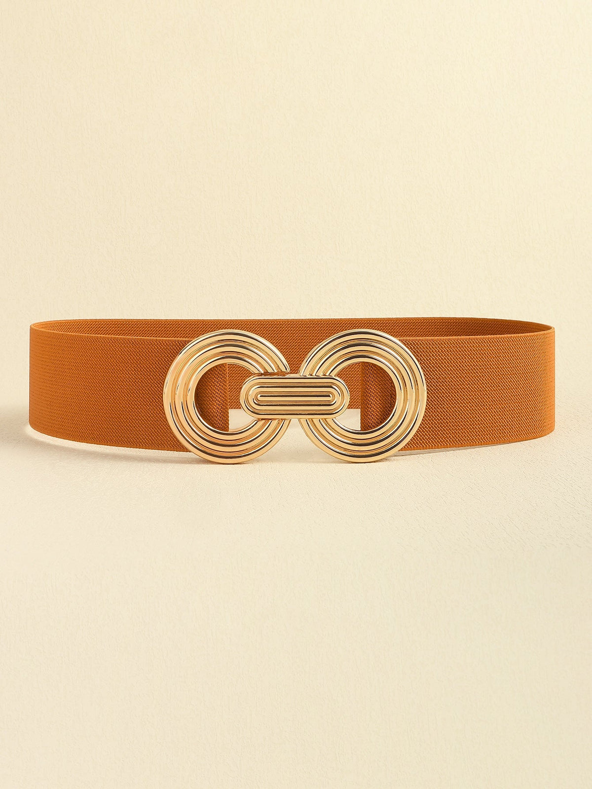 Rust-brown elastic wide belt featuring a polished gold alloy geometric buckle with interlocking rounded forms and a sleek, broad silhouette.