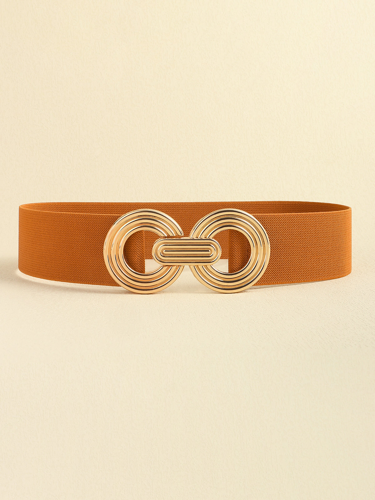 Rust-brown elastic wide belt featuring a polished gold alloy geometric buckle with interlocking rounded forms and a sleek, broad silhouette.