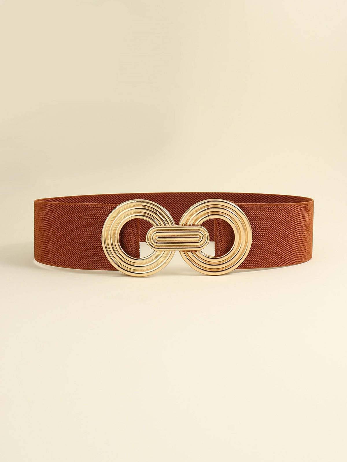 Brown elastic wide belt with a sleek 2-inch band and polished gold-tone geometric buckle featuring interlocking rounded forms and layered detailing.