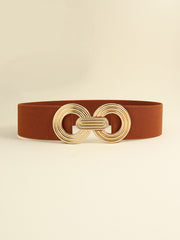 Brown elastic wide belt with a sleek 2-inch band and polished gold-tone geometric buckle featuring interlocking rounded forms and layered detailing.