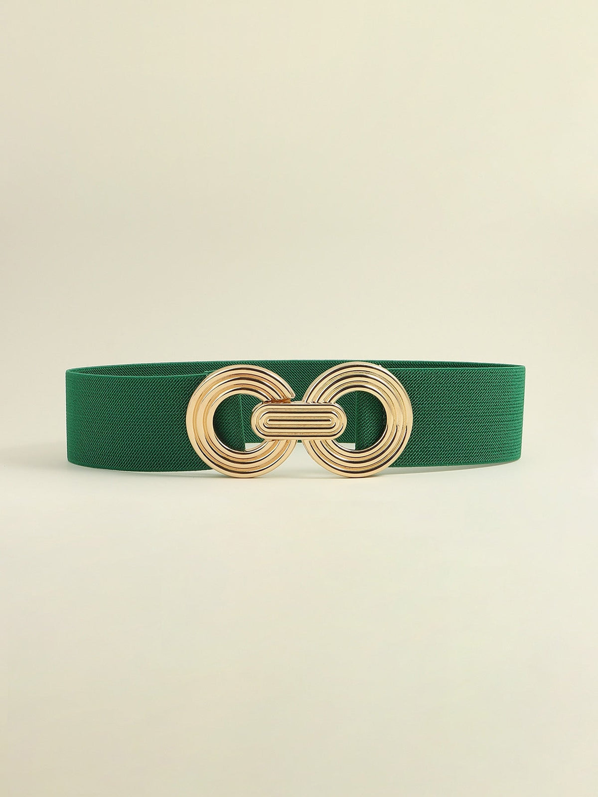 Green elastic wide belt with a polished gold-tone geometric buckle featuring interlocking rounded forms and a layered, dimensional design.