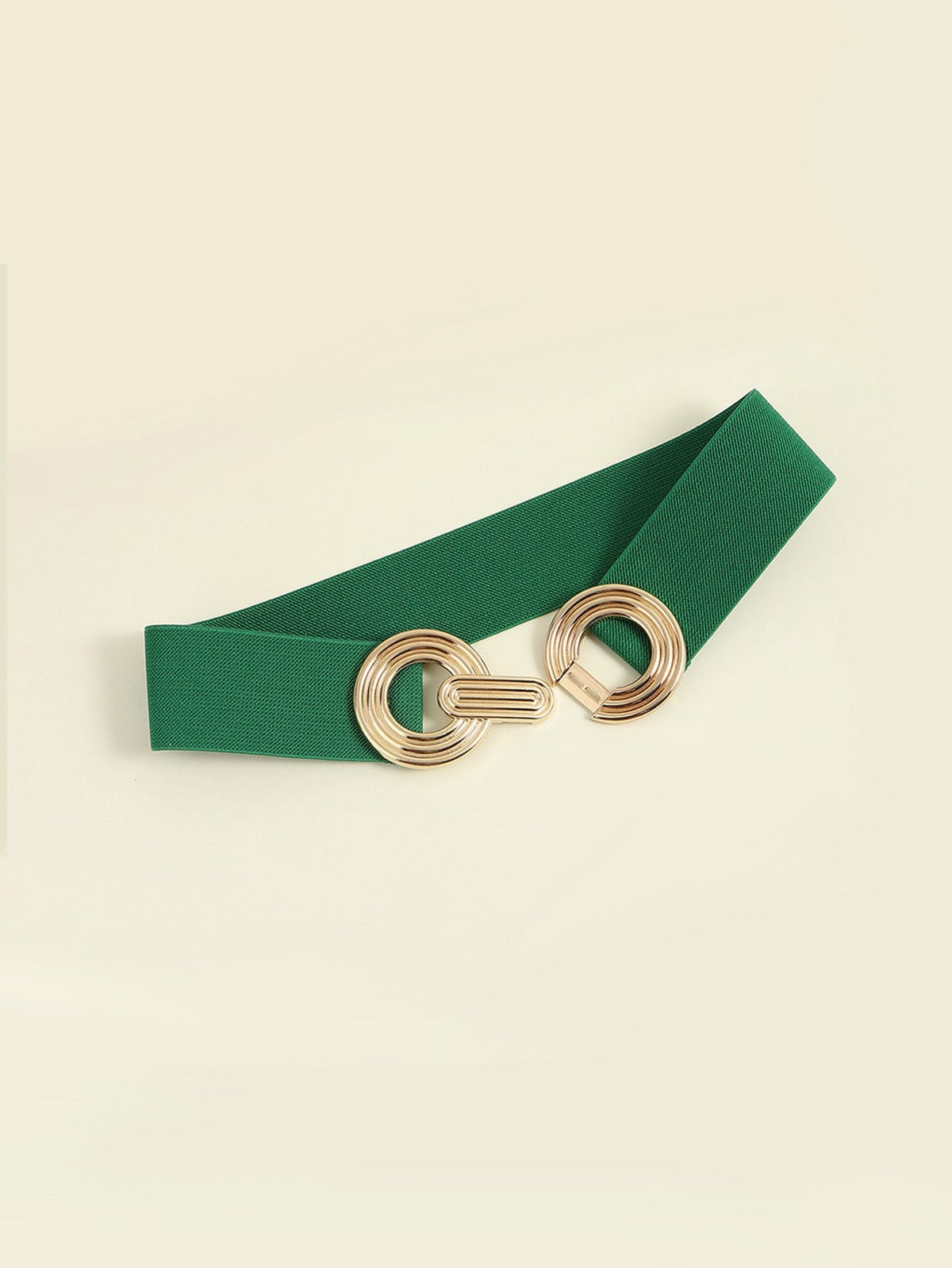 Green elastic wide belt with a broad profile and polished gold-tone geometric buckle featuring interlocking rounded forms and layered construction.