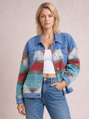 Model poses with one hand in her jeans pocket wearing a blue geometric button-up denim jacket with dropped shoulders, a collar, long sleeves, and a relaxed silhouette.