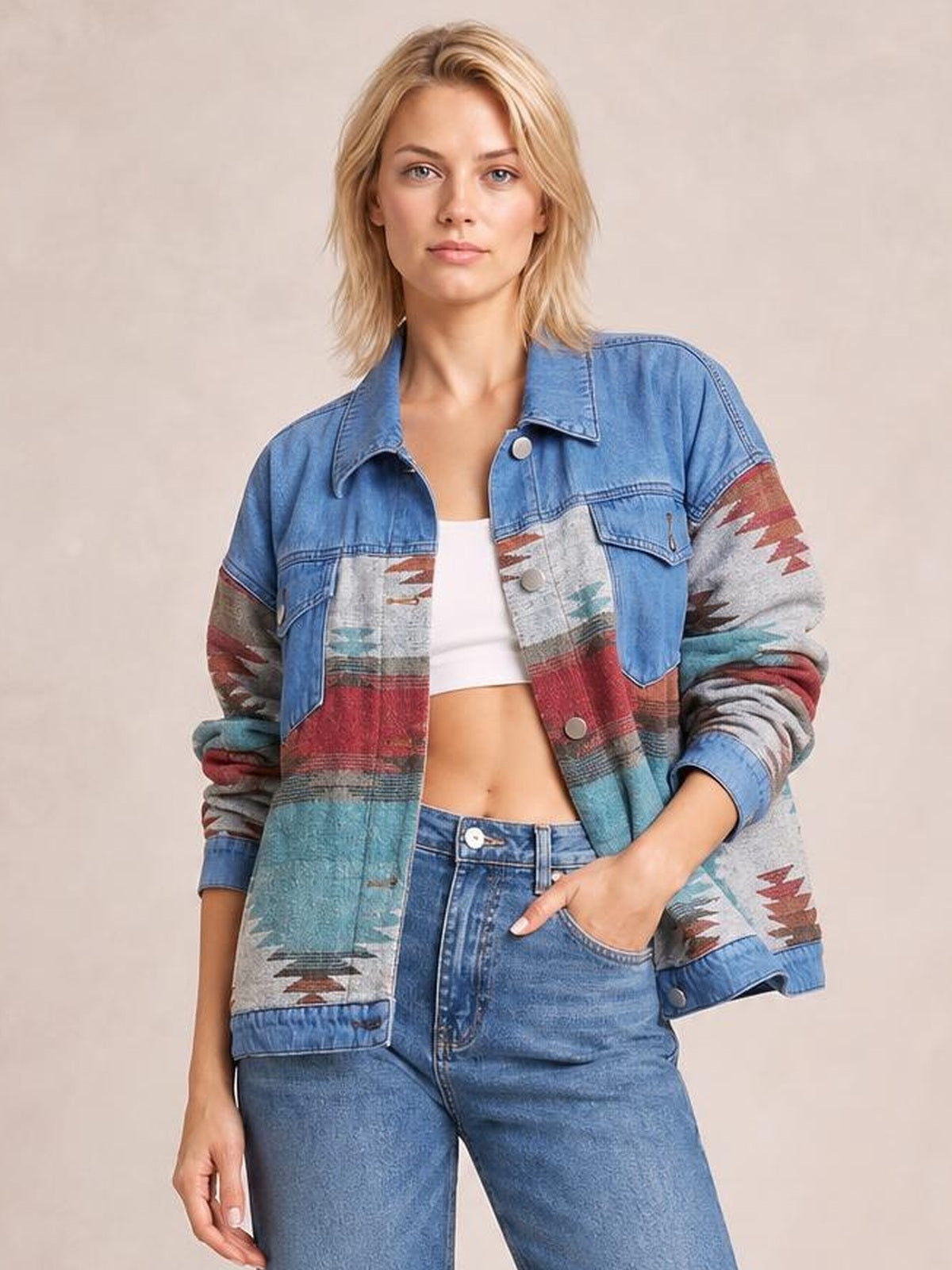 Model wears a blue geometric button-up denim jacket with dropped shoulders, patch pockets, contrast patterned panels, and a relaxed silhouette.
