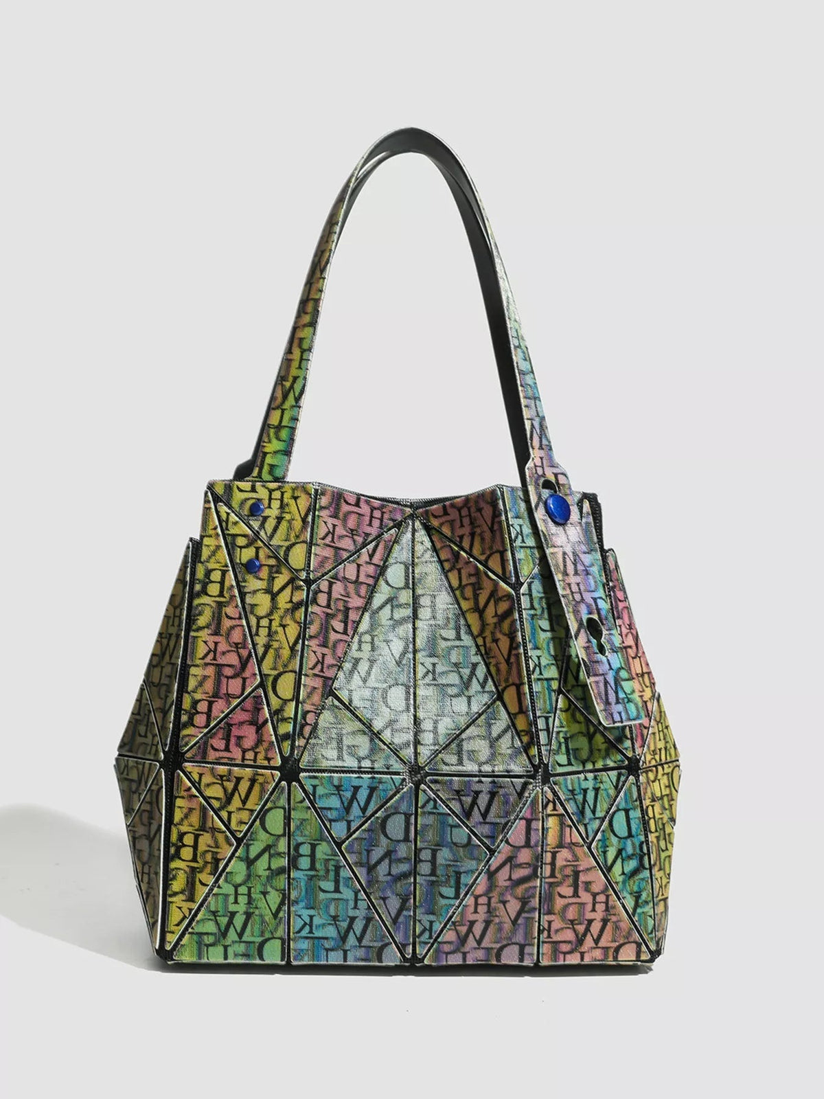 Medium geometric iridescent PVC shoulder bag with a colorful lettered print, structured trapezoid silhouette, angular panel construction, and long shoulder straps.