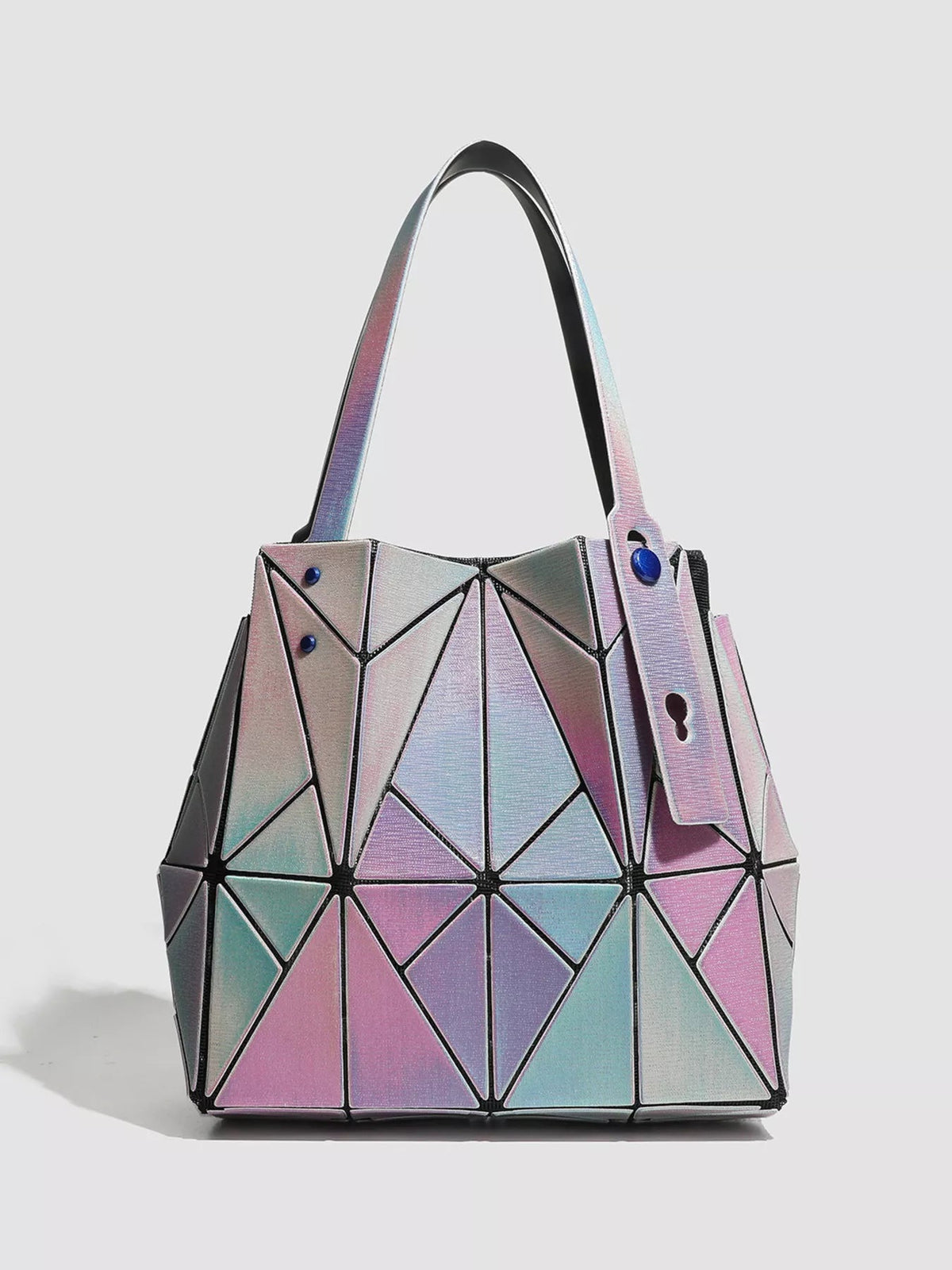 Medium PVC shoulder bag with a structured silhouette, iridescent pink, blue, and silver geometric panels, long straps, and blue stud accents.