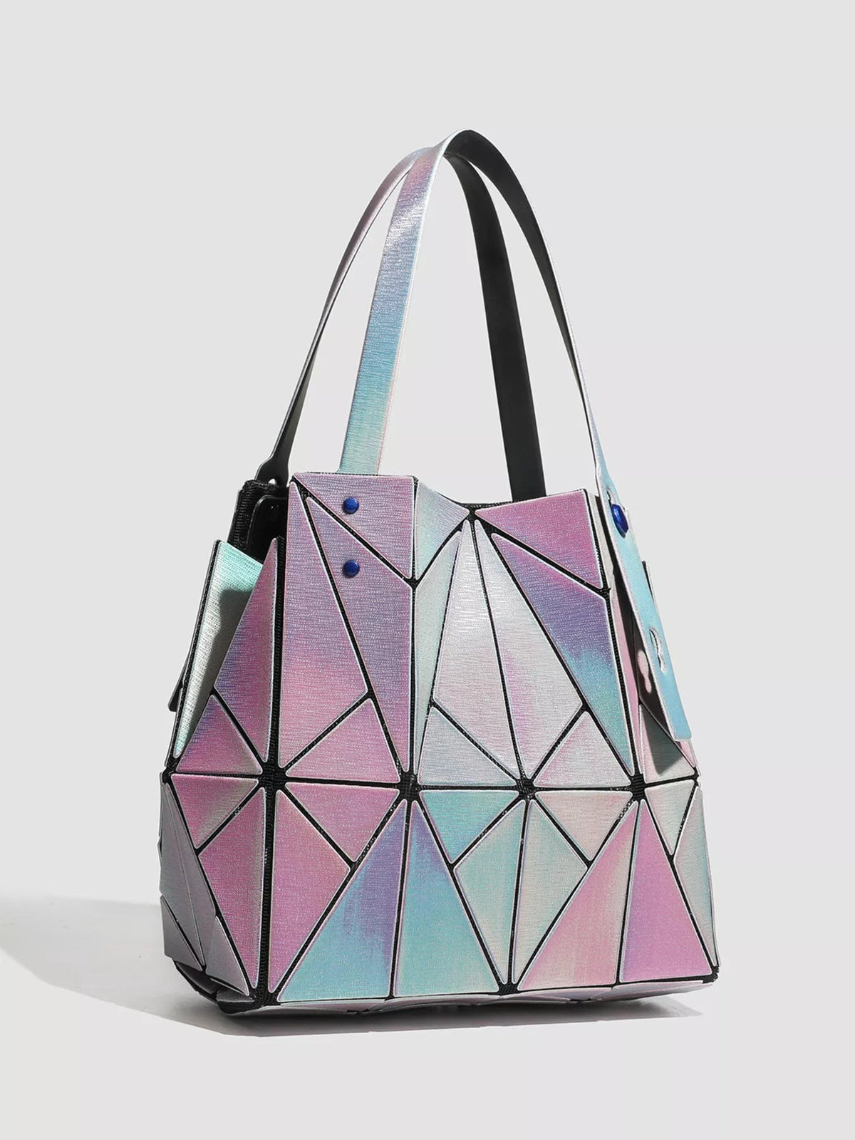 Medium PVC shoulder bag with an iridescent pink, blue, and silver geometric design, structured silhouette, black trim, and dual shoulder straps.