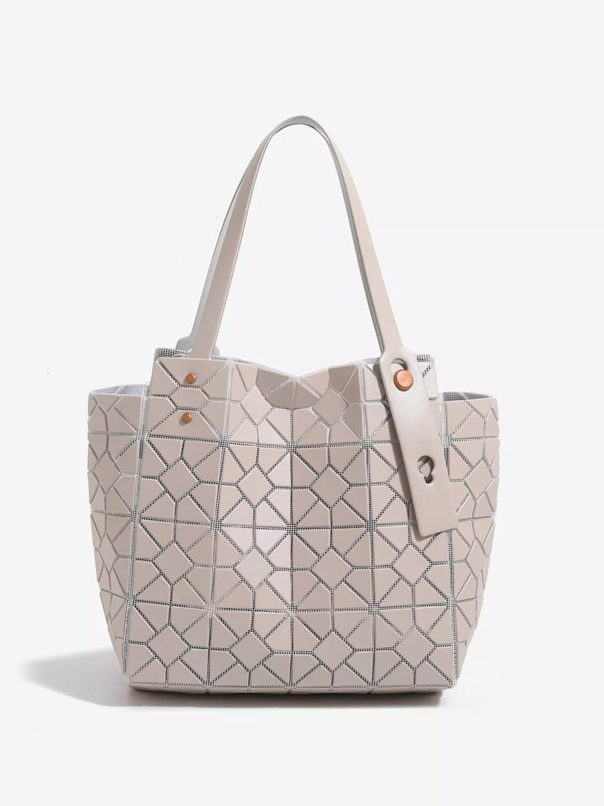 A medium structured PVC handbag in pale beige features a geometric lattice pattern, spacious tote silhouette, twin handles, and decorative rivet fastening.