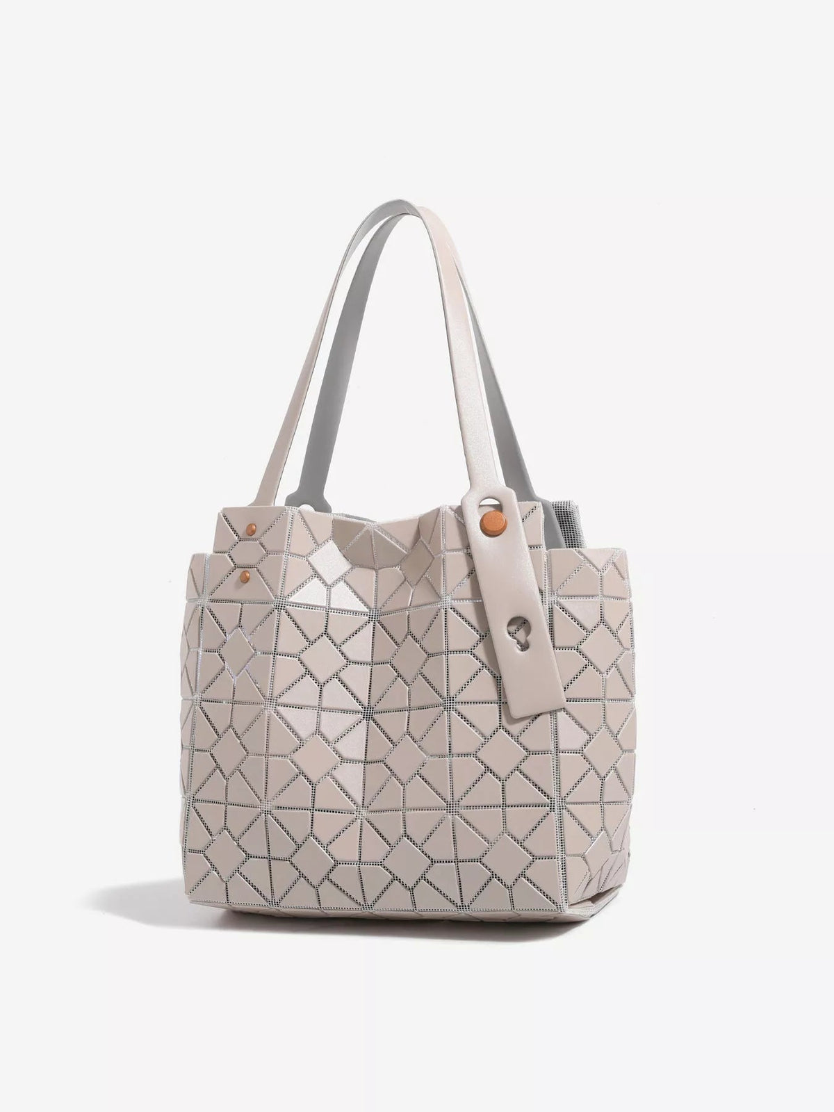 Medium beige PVC tote with a structured silhouette, geometric lattice pattern, twin handles, and a wide fastening strap with round studs.