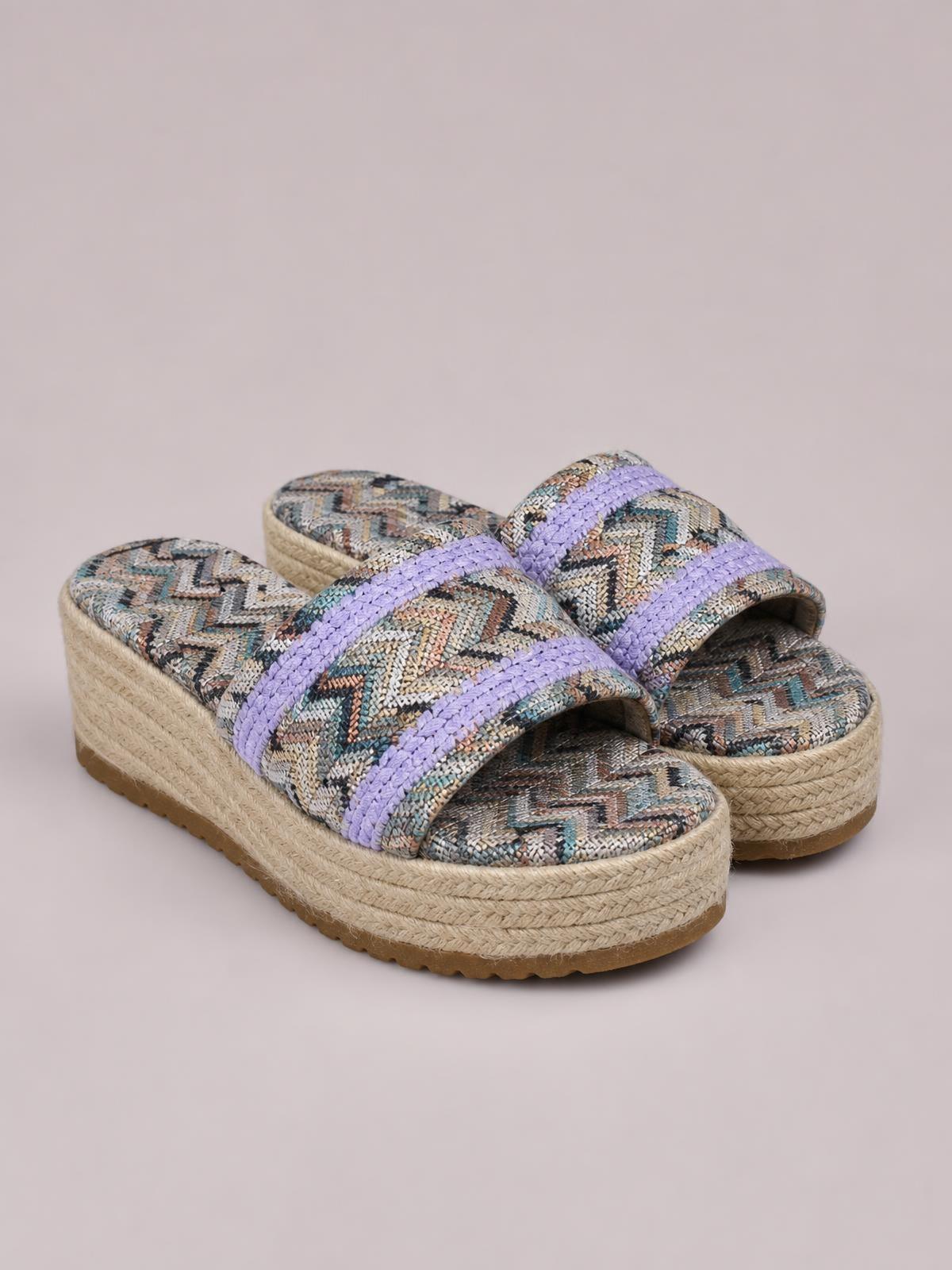 Geometric open toe platform sandals with lavender woven straps, multicolor patterned uppers, and thick braided espadrille-style soles.