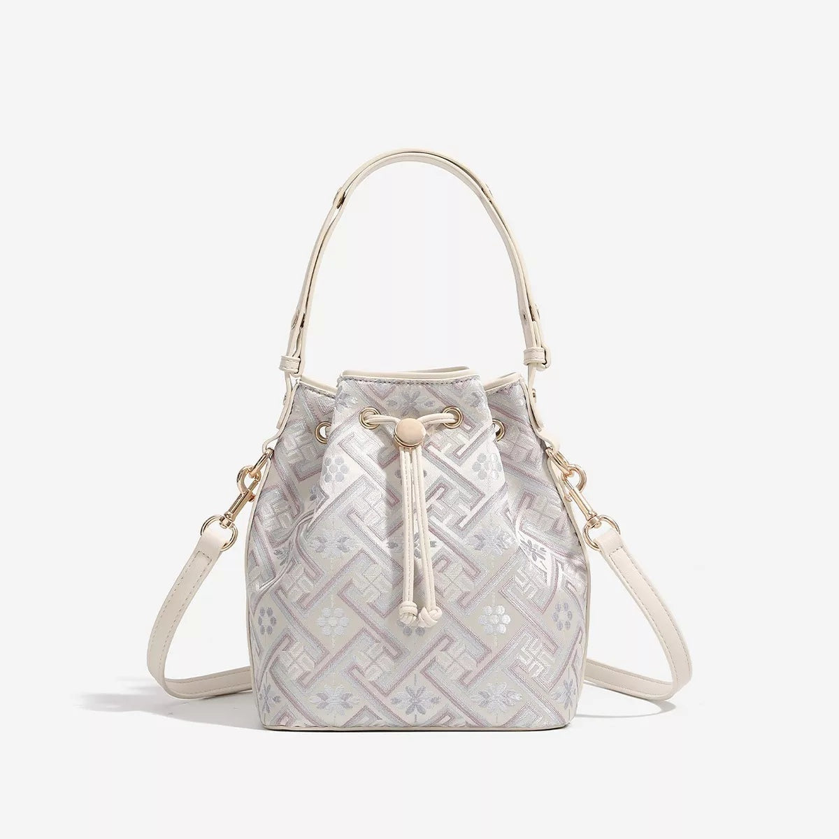 Small cream PU leather bucket bag with a geometric patterned finish, drawstring closure, top handle, and detachable crossbody strap.