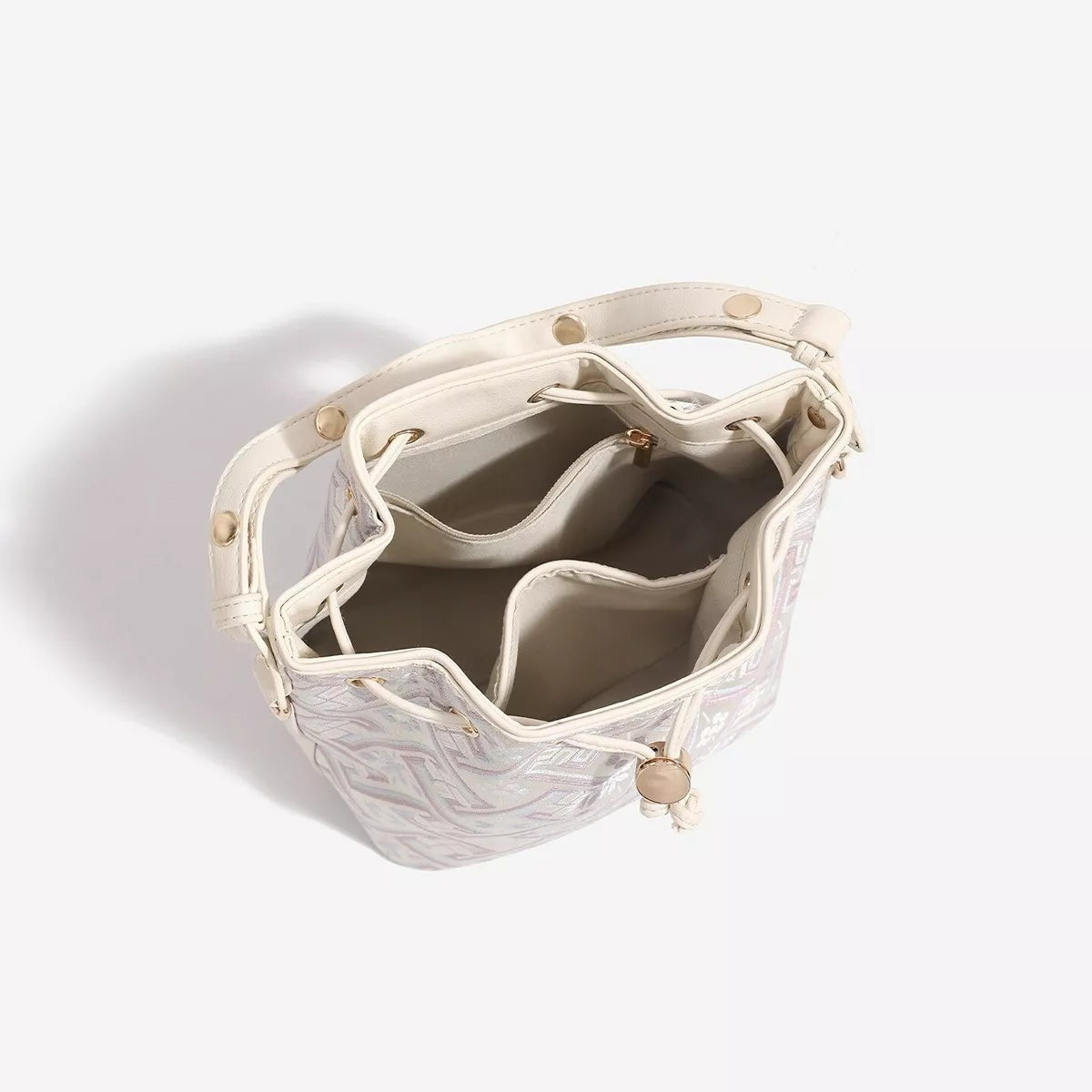 Small PU leather bucket bag with a pale geometric pattern, drawstring closure, structured top handles, and an open interior with multiple compartments.