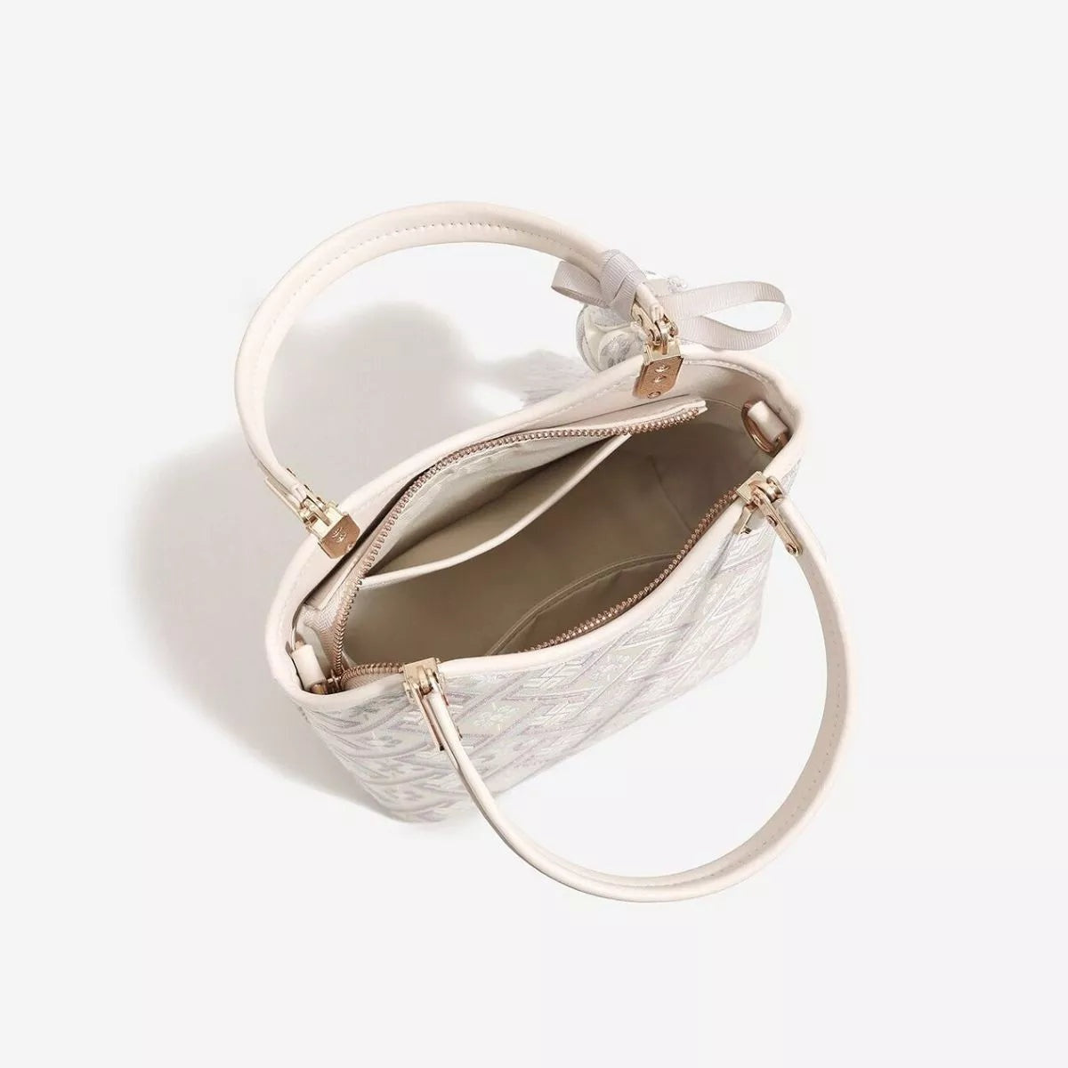 A small off-white geometric pattern handbag with rounded top handles, a long shoulder strap, zip compartments, and gold-tone hardware.