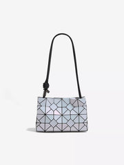 Small geometric prism iridescent shoulder bag in reflective PVC with a structured rectangular silhouette, faceted panel construction, and a long black strap.