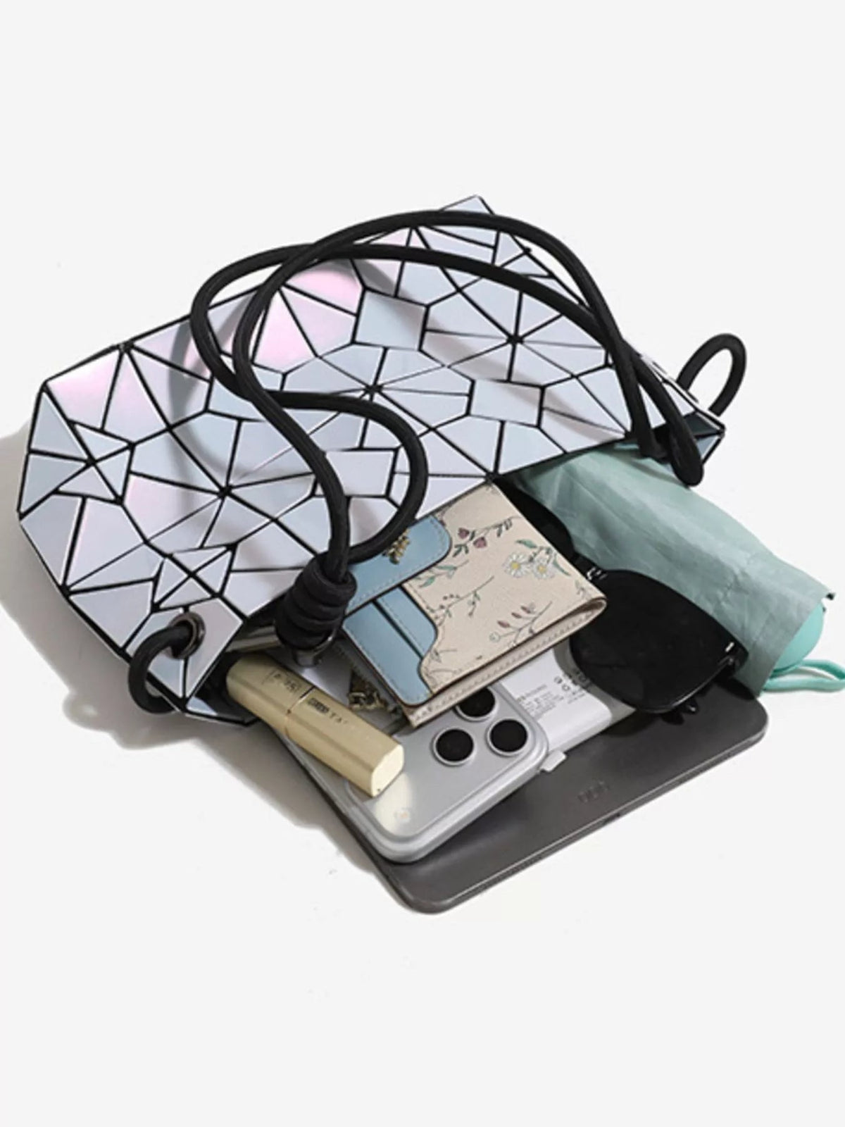 Small geometric prism iridescent PVC shoulder bag with a translucent faceted silhouette, black edging, and double shoulder handles.