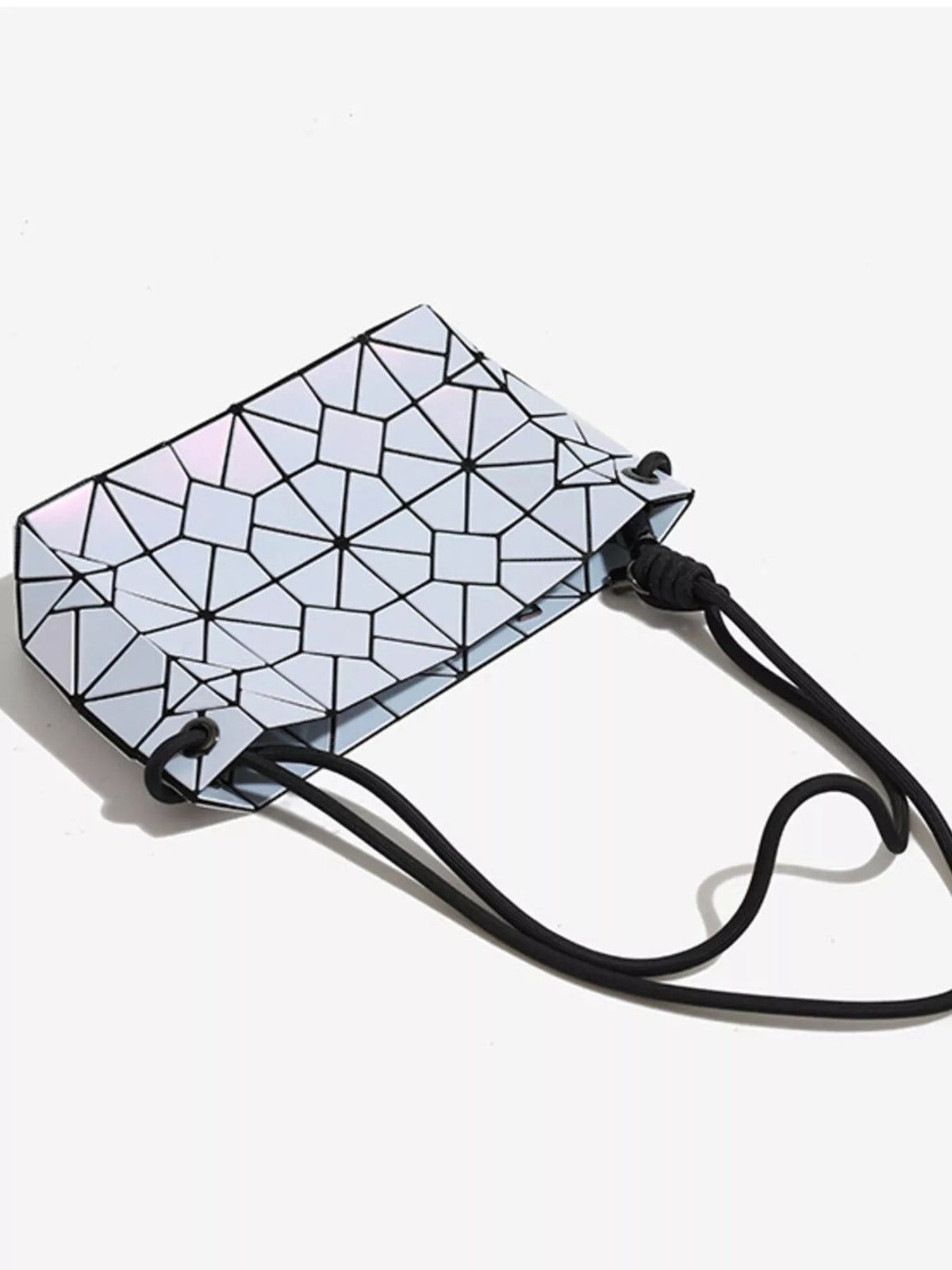 Small geometric prism shoulder bag in iridescent pale blue and pink PVC, featuring black line detailing and a long black strap.