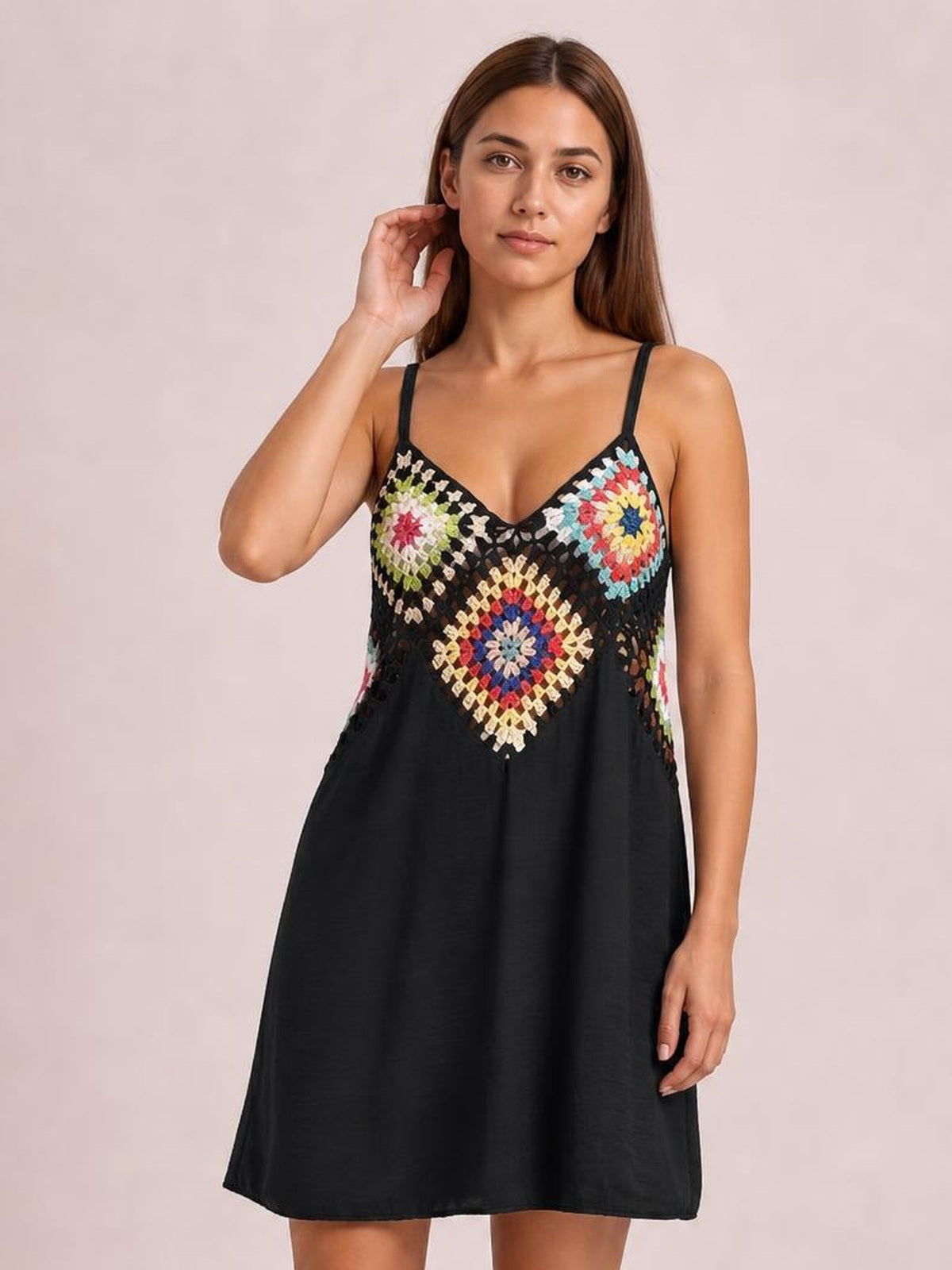 Model poses in a black geometric V-neck spaghetti strap cover-up dress with a semi-sheer multicolor patterned bodice and relaxed A-line silhouette.
