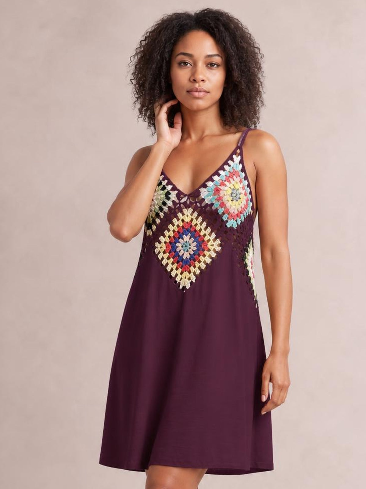 Model poses in a burgundy geometric V-neck spaghetti strap cover up dress with a colorful patterned bodice and relaxed A-line silhouette.