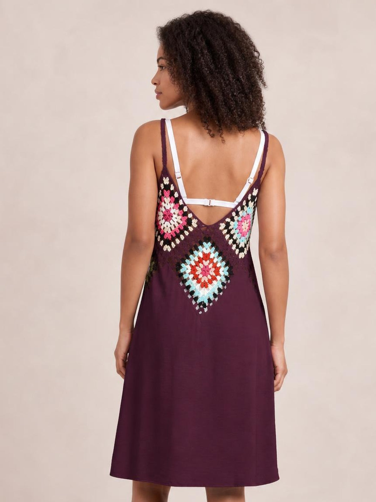 Model shown from behind wearing a burgundy geometric V-neck spaghetti strap cover up dress with a relaxed A-line silhouette and semi-sheer crochet panel.