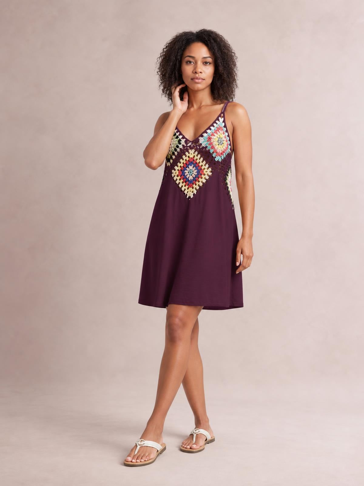 Model poses in a burgundy geometric V-neck spaghetti strap cover up dress with colorful patterned detailing and a relaxed A-line silhouette.