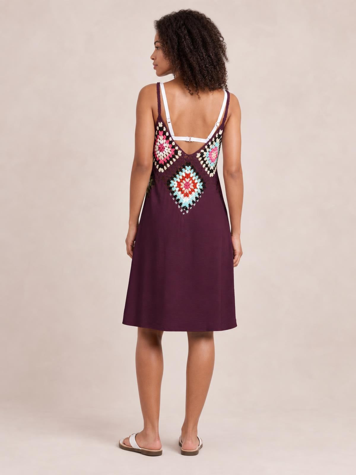 Model shown from the back in a burgundy geometric spaghetti-strap cover-up dress with a relaxed straight silhouette and knee-length hem.