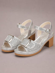 Silver glitter sandals feature open toes, wide buckle straps, ankle straps, and comfortable mid-height block heels with textured rubber soles.