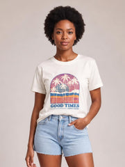 A model poses in a white graphic round neck short sleeve T-shirt with a colorful palm tree print and relaxed straight silhouette.