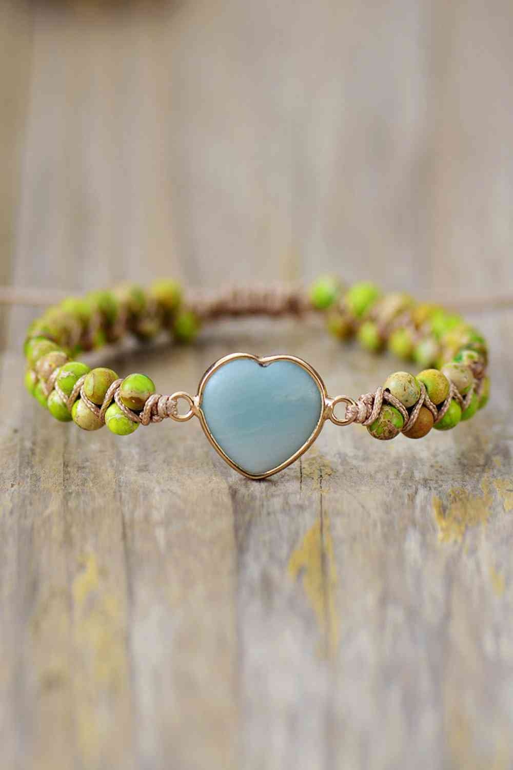 Handmade heart shape natural stone bracelet with green beaded strands, a smooth blue heart centerpiece, and copper-tone links in a modern silhouette.