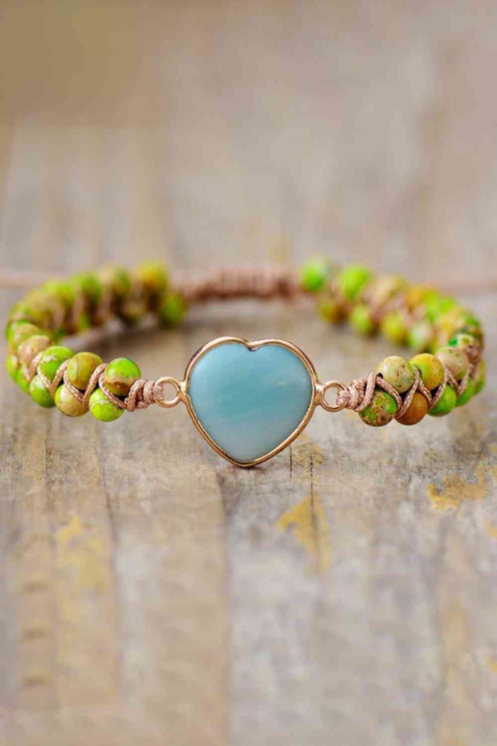 Handmade modern heart shape natural stone bracelet with a blue heart centerpiece, green patterned beads, and copper-toned wire detailing.
