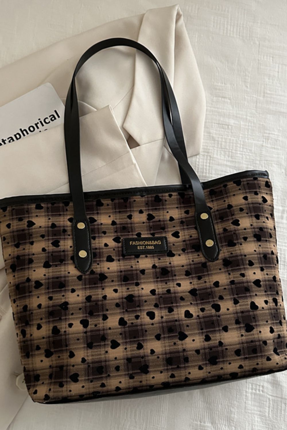 Medium Heart Plaid tote bag in brown canvas features a structured silhouette, black PU leather shoulder straps, and an allover heart print.
