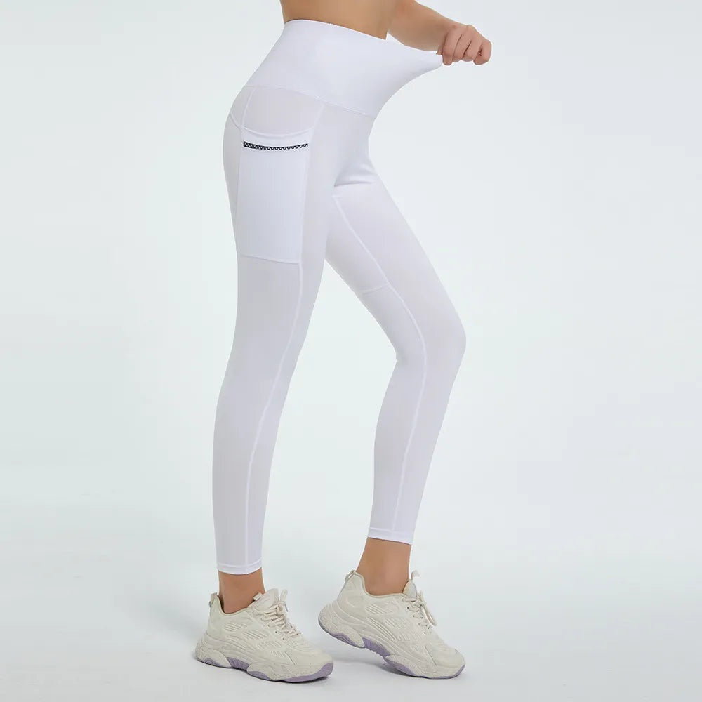 Model in a side pose wears white high-waist active leggings with a fitted full-length silhouette, smooth stretch fabric, and a visible side pocket with contrast trim.